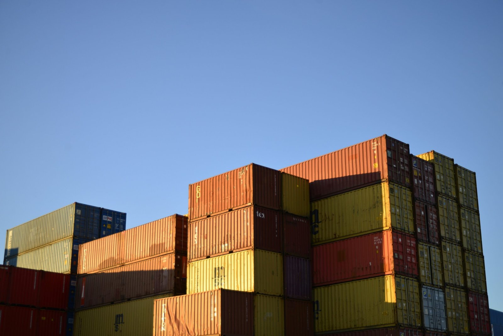 Shipping containers stacked at a cargo supply yard